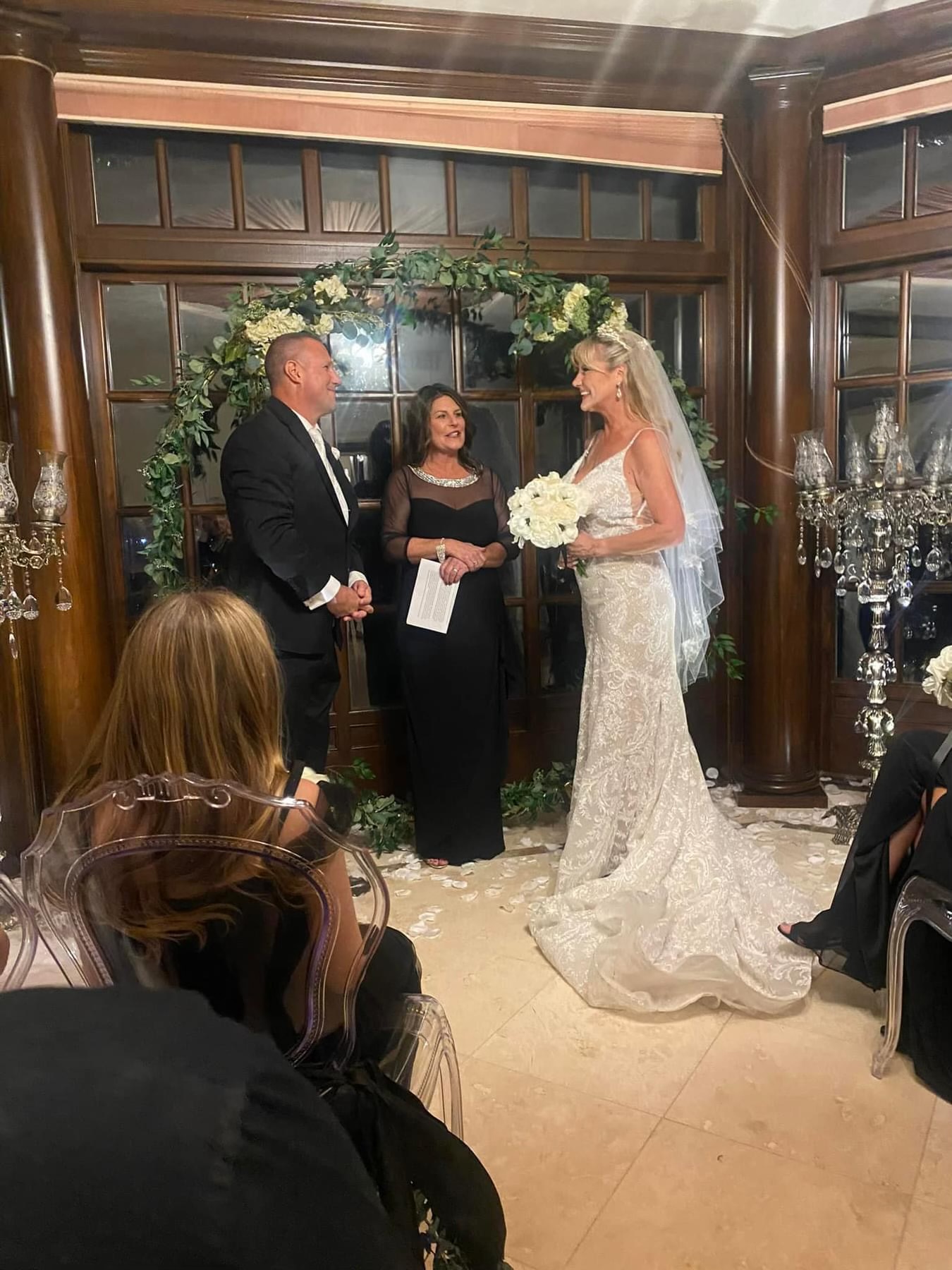 Wedding ceremony with floral arch and crystal candelabras